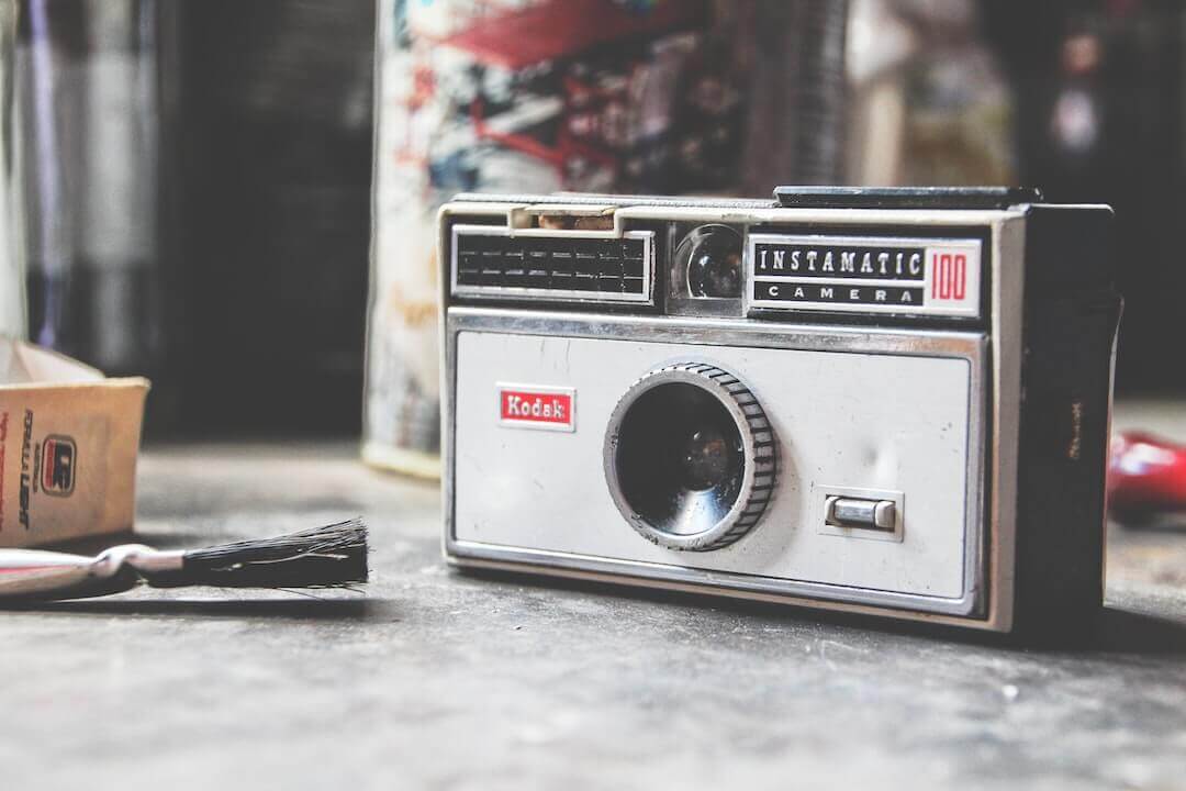 Vintage Kodak Instamatic camera on a rustic surface, capturing a nostalgic urban vibe.