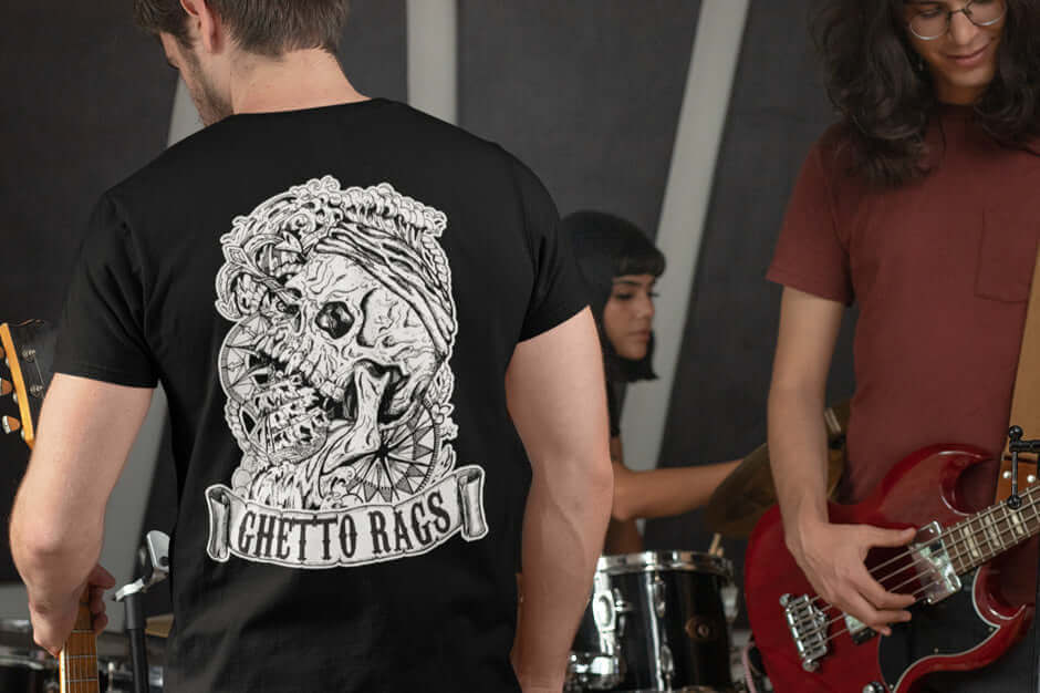 "Man wearing Ghetto Rags Hold Fast shirt featuring edgy graphic design, band practice in background"