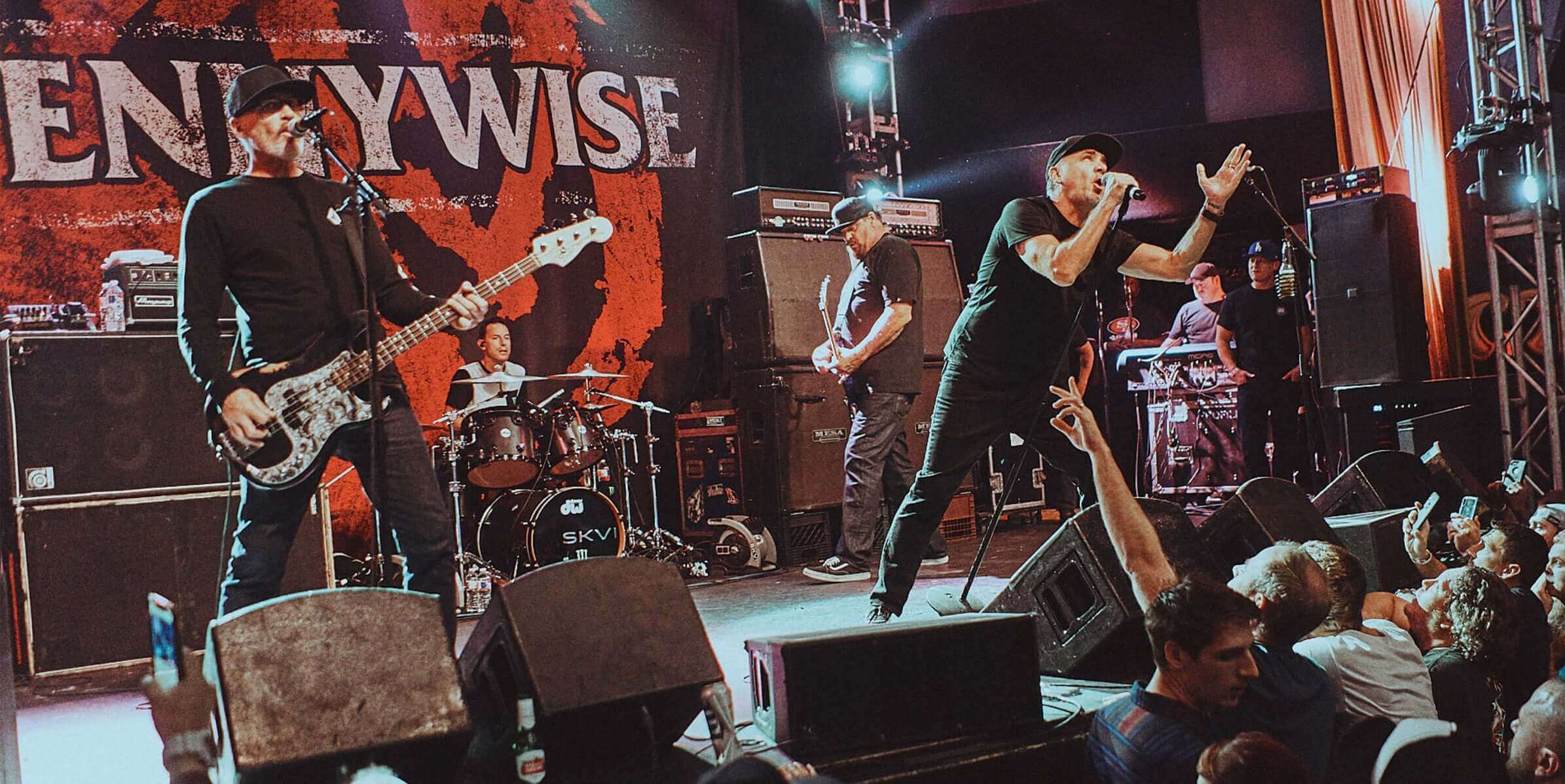 Pennywise performing live on stage, capturing the energy of the Southbay punk band with a vibrant crowd.